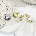 Detailed view of 18K gold plated marine charms including starfish and shell for DIY jewelry - Silver Scallop