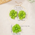 Detailed macro view of vibrant green flower pendant with pearl and golden snake chain necklace - Green