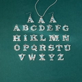 Close-up of vintage silver letter pendants with turquoise stones and western engravings - Letter B (X878-B)