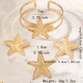 Close-up of golden starfish jewelry set on white sand showing detailed surface texture - Starfish Three-Piece Set (X670) / Gold