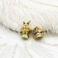 Close-up of golden magic rabbit and carousel charms with sparkling crystal detail - Carousel