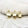 Macro view of three different sizes of 18K gold plated geometric lobster clasps on lace - Square Left Side / Gold
