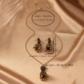 Retro gold flower bell jewelry set with necklace and earrings on silk background - Antique Gold
