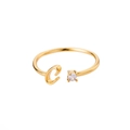 Detail of adjustable gold ring featuring letter C design and sparkling round zircon - Letter C / Gold