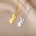 Macro shot of gold and silver mother-to-be silhouette pendants on satin fabric - Pregnant Woman With Ponytail Silhouette / Gold