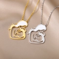 Detailed close-up of gold and silver mother and child pendants on silk fabric - Mother And Child Enamel Hollow Style / Gold