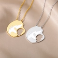 Detail of stainless steel mother and baby silhouette pendants on champagne velvet - Mother And Child Silhouette