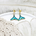 Macro detail of whale tail earrings with blue enamel, gold plating and small crystals - Blue Fish Tail Pair 17.5*24mm