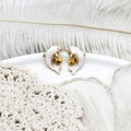 Macro view of gold dolphin earrings with white enamel and sparkling zircon accents - Dolphin Pair 11*15.8mm