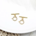 Detailed macro of 18K gold plated brass OT toggle clasp with micro-set zircons on white plate - S1 / Full Zirconia Large Round