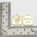 Detail of square 18K gold plated pendants featuring rose relief and Forever Love engraving - Rose Square Charm