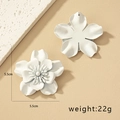 Detail view of large white floral earrings with matte finish and 5.5cm size markings - White