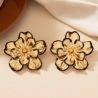 Elegant gold flower stud earrings with black trim in a stylish five-petal floral design - Black Edged Gold