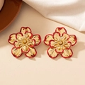 Vintage layered flower stud earrings in red and gold finish for a stylish feminine look - Red Edged Gold