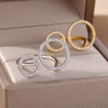 Detail of layered gold and silver geometric rings with sparkling zircon pavé in a jewelry box - Hollow Double Round Style (4471) / Gold