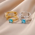 Macro shot of gold and silver layered rings with heart and square zircon on silk - Heart and Square Cut Zirconia Style (4439)