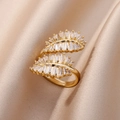 Macro shot of gold leaf ring with rectangular zircons on champagne silk fabric - Gold Cross Baguette Cut Style (JZ4464G)