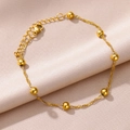 Detail of 18k gold plated stainless steel anklet with 8 polished beads on silk cloth - Gold Eight Beads Style (HJ375G)