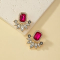 Detail of vintage gold earrings with large ruby red stone and crystal accents - Rose Red Style (E843)