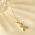 Golden crown letter A necklace with micro-pave crystals on water ripple background - Letter A