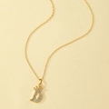 Detail of gold letter D pendant with crown design and sparkling crystal inlay - Letter D