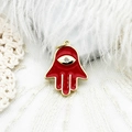 Detailed view of red enamel Hamsa hand pendant with evil eye and gold plating - Hamsa Hand