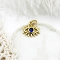 18K gold plated evil eye pendant with deep blue zircon stone on white lace background - Eyelash Evil Eye