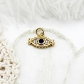 Macro shot of micro-pave evil eye pendant in 18K gold plating with blue crystal - Eyelash Full Zirconia Eye