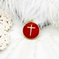 Detail of red enamel round pendant with gold cross on white lace background - Cross Disc