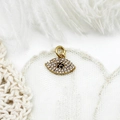 Macro shot of 18K gold plated evil eye charm with micro-pave cubic zirconia stones - Full Zirconia Blue Eye