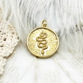 Golden round snake pendant with 18k gold plating and embossed sunburst detail - Round Snake