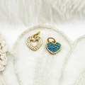 Macro detail of micro-paved heart charms in gold finish on elegant white lace and feathers - Hollow Heart / 10.3*9.5mm