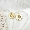 Close-up of 18K gold plated hollow queen portrait pendants on an elegant lace background - Face