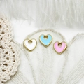 Macro detail of heart-shaped enamel charms in three colors for DIY jewelry making - Blue Double-Sided Enamel Heart
