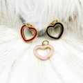Detailed macro of 18K gold plated heart pendants in red, black, and pink enamel - Black Hollow Heart