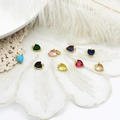 Detailed close-up of colorful heart-shaped zircon pendants with gold plated edges for DIY jewelry - Heart Pendant / Yellow