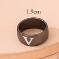 Macro detail of black enamel wide band ring featuring a bold white letter V design - Letter V Design / Gunmetal Letter V
