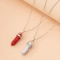 Detail shot of hexagonal bullet stone pendants with natural texture on silver chains - Red