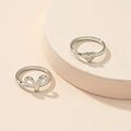 Detail view of silver rings featuring heart shape with ME engraving and zodiac symbol - US 7 / Aries
