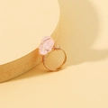 Bohemian adjustable pink crystal stone ring with gold wire wrap on a beige pedestal - Adjustable Open / Pink