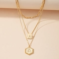 Detailed macro view of layered gold necklace with rectangular and hexagonal letter A pendants - Letter A (X366-A)