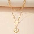 Detail of layered gold necklaces featuring hexagon and square pendants with the letter J - Letter J (X407-J)