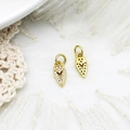 Macro shot of gold arrow pendants with micro-pave zircons for DIY jewelry assembly - Shield