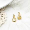 Detail of drop-shaped gold pendants with zircon hearts and LOVE engraving on lace - Teardrop LOVE