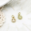 Close-up of gold peace sign charms with white zircon inlay for DIY jewelry design - Peace Sign Circle