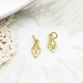 Macro shot of gold-plated geometric rhombus pendants with tiny zirconia for DIY jewelry - Diamond