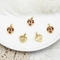 Close-up of heart-shaped Fu character pendants in red enamel and gold finish - Heart Fu-White Shell