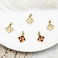 Detailed view of 18K gold plated Fu pendants with red enamel and white mother of pearl - Square Fu-White Shell
