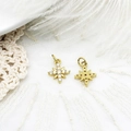 Macro detail of gold North Star charm with white zircon stones and honeycomb back - Hexagram