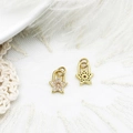 Close-up of gold star pendant with zircon pavé setting and detailed lobster clasp - Star